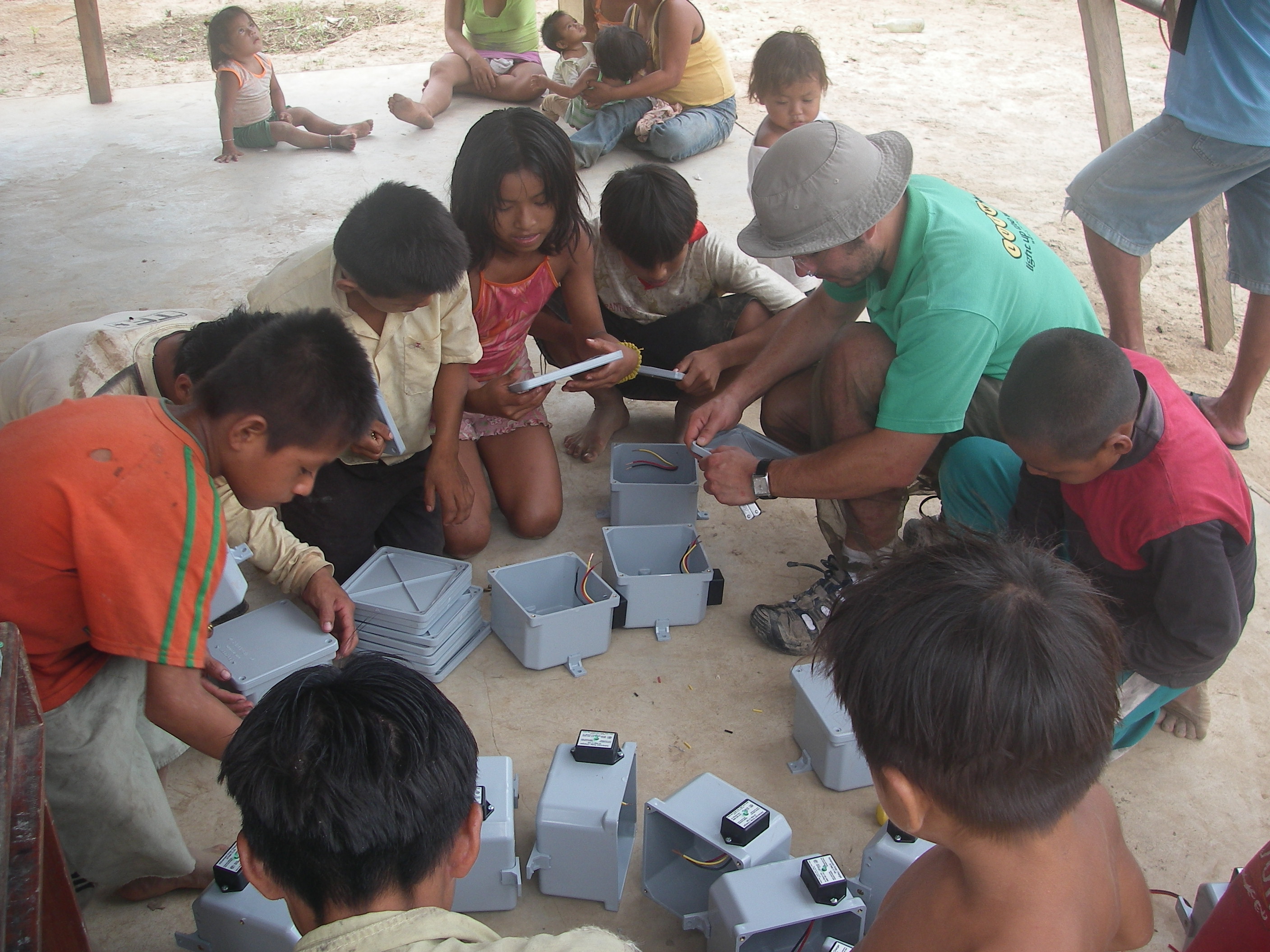 Children being shown charge controllers in the Peruvian Jungle
